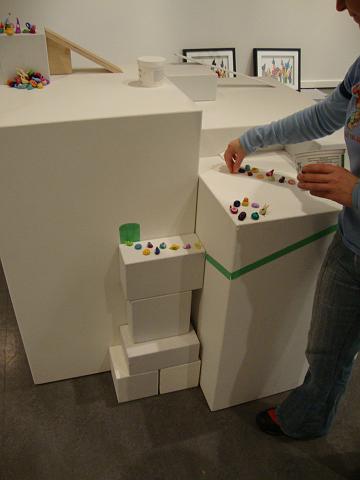 install - an assent of polymen (10).JPG - the original concept of having the polymen laid out on a flat plinth was modified when the gallery produced various heights of plinths and some mini-plinths